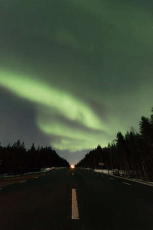 Frozen land in scandinavia and Aurora in the skyの写真素材