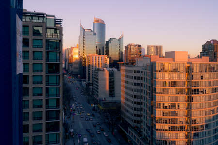 Early morning or sunset shot of illuminated buildings by sun and streets in shadow