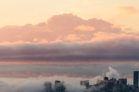 Vancouver in morning fog while sun rising behind clouds