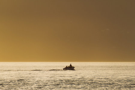 Golden hour on shore with rocks and ocean