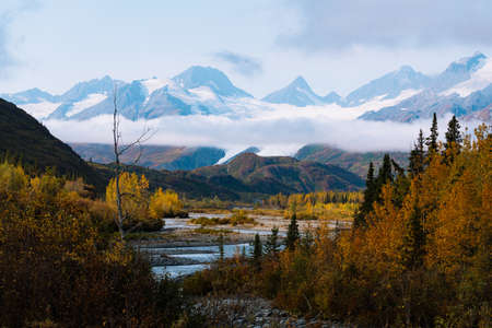 Remote mountain range with river and in autumn season during sunrise in Alaskaの写真素材