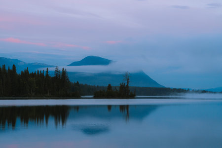 Morning before Sunrise during autumn season with reflections on calm lake in Alaska