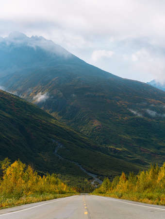 Seasonal color of landscape with forest, mountains and rivers in autumn colors in Alaska during sunsetの写真素材