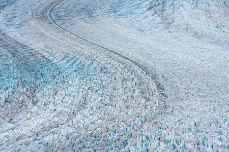 Detail of blue frozen glacier and its crevasse in Alaskaの写真素材