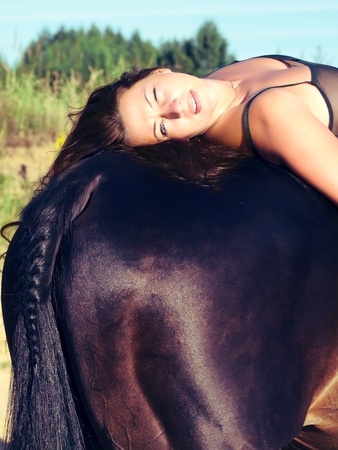 pretty women laeing on bag  horse の写真素材