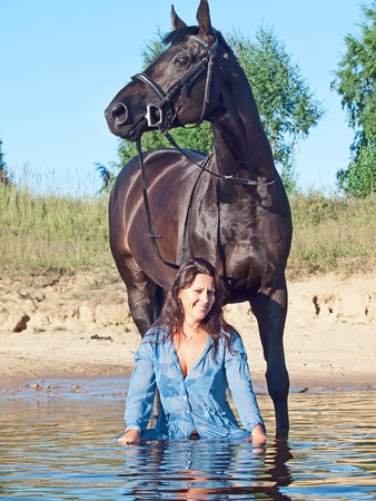 pretty women with black horse の写真素材