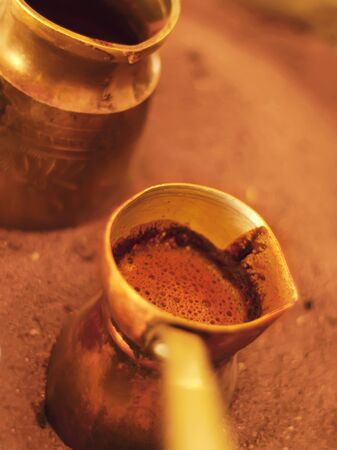 traditional greek coffee on a sandの写真素材
