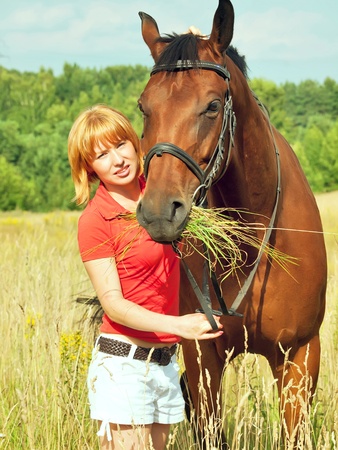 young girl  with her horse の写真素材