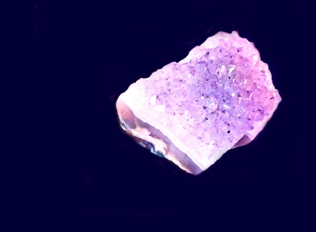 Amethyst mineral isolated on dark purple background の写真素材