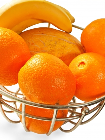 Metal  basket with orange fruits isolated on a white backgroundの写真素材