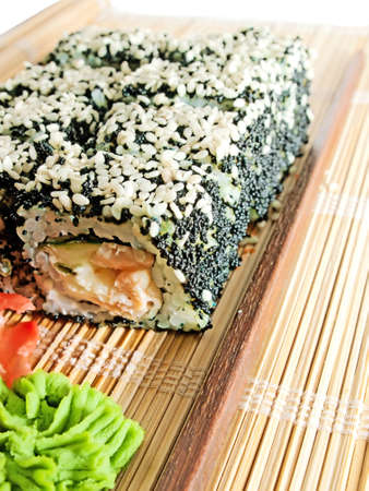 sushi rolls with black roe and sesame on bamboo matの写真素材