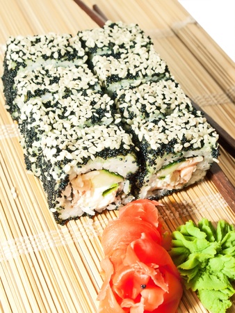 sushi rolls with black roe and sesame on bamboo matの写真素材