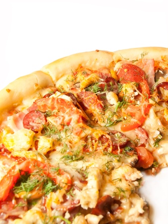 Pizza with  salamy, becon, chicken isolated on whiteの写真素材