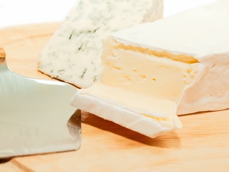Brie and dor blue cheese on wooden desk with knife isolated の写真素材
