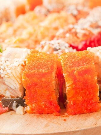  sushi rolls with  orange masago on the deskの写真素材