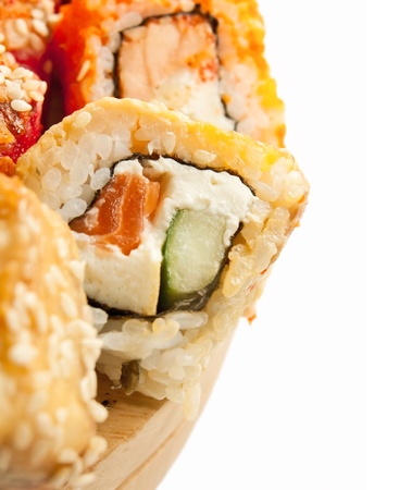  sushi rolls in range on the desk closeup isolated on whiteの写真素材