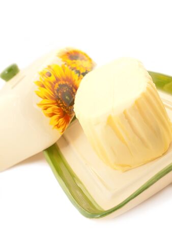 butter on white butterdish over whiteの写真素材