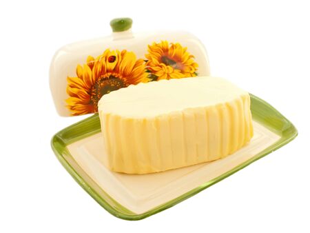 butter on white butterdish over whiteの写真素材