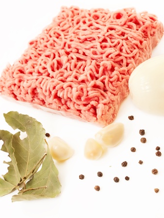 Minced meat with spices and garlic on white backgroundの写真素材