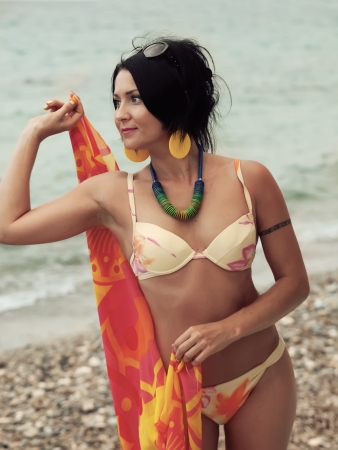 woman in bikini and pareo at sea backgroundの写真素材