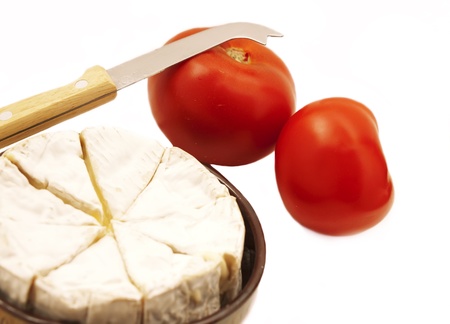 camembert cheese with tomatos and knife on white の写真素材