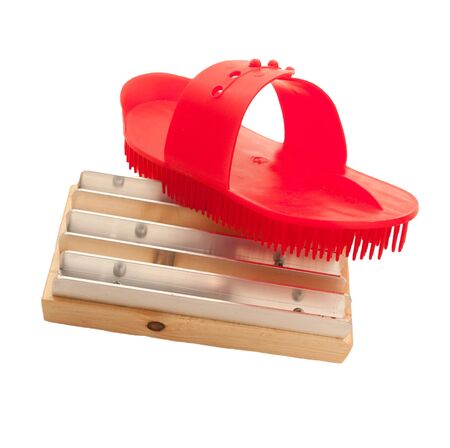 red plastic and metal comb isolatedの写真素材