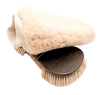  brush with natural bristle and sheepskin mitten isolated の写真素材