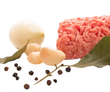 Minced meat with spices and garlic on white backgroundの写真素材