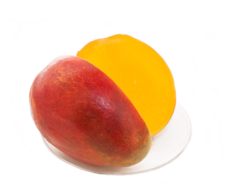 Half cut mango fruits on plate over whiteの写真素材