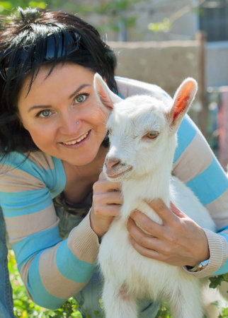 Girl with baby goat  focus at goatの写真素材
