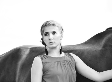 young beautiful serious  girl  with  horseの写真素材