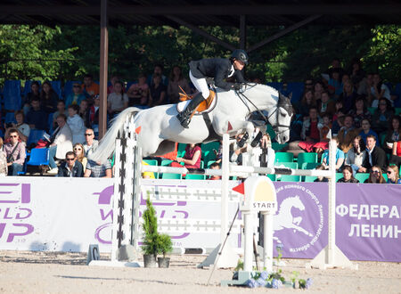 SAINT PETERSBURG-JULY 05: Rider Mikhail Safronov on Copperphild in the CSI3*-W/CSIYH1* International Jumping Grand Prix FEI World Cup Competition 150 cm on July 05, 2014 in Saint Petersburg, Russia.のeditorial素材