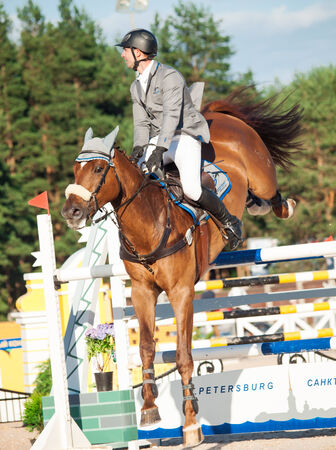 SAINT PETERSBURG-JULY 05: Rider Maxim Kryna on Klooney 26 in CSI3*-W/CSIYH1* International Jumping Grand Prix FEI World Cup Competition 150cm on July 05, 2014  in Saint Petersburg, Russiaのeditorial素材