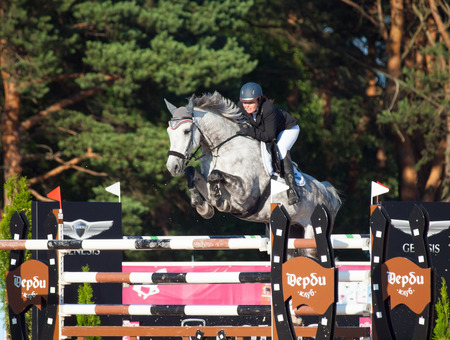 SAINT PETERSBURG-JULY 05: Rider Maria Khimchenko on Calina in the CSI3*-W/CSIYH1* International Jumping Grand Prix FEI World Cup Competition 150cm on July 05, 2014 in Saint Petersburg, Russia.のeditorial素材