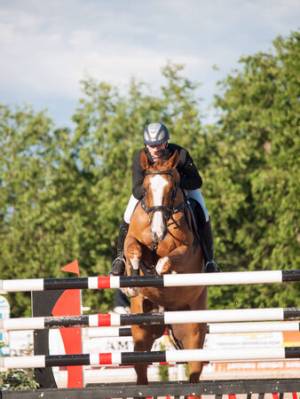 SAINT PETERSBURG-JULY 05: Rider Kristupas Petraitis on Barichela in the CSI3*-W/CSIYH1* International Jumping Grand Prix FEI World Cup Competition 150cm on July 05, 2014 in Saint Petersburg, Russia.のeditorial素材