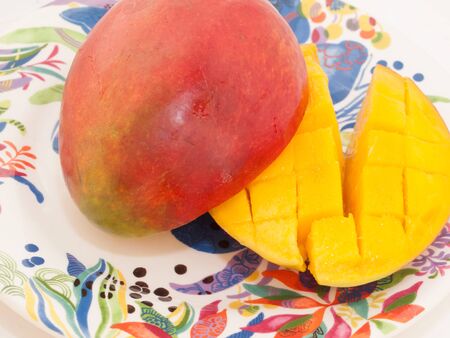 Ripe Mango with slices on plateの写真素材
