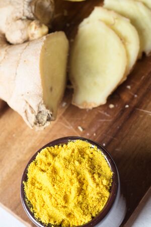 Spices and herbs in ceramic bowls. curcuma and ginger seasoning. Colorful natural additives.の写真素材