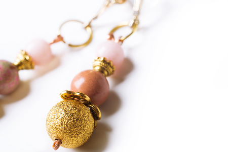 gold earrings with pink semipreciouses. nephritis and varisciteの写真素材