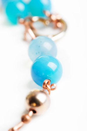 jewerly bracelet  with chalcedony and obsidian around white backgroundの写真素材