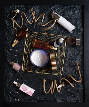 set of nature precious oils and  care cosmetics on black background .の写真素材