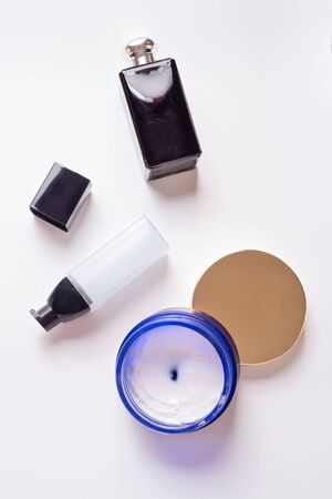 Black fragrance bottle with precious essence and cream for youth skin around white background. Flat layの写真素材