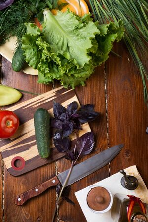 cooking green  salad from organic vegetables around wooden table. flat layの写真素材