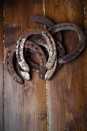 Lucky old  horseshoes laying at wooden floor.の写真素材