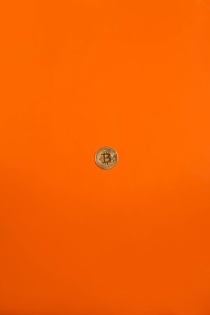 golden bitcoin around orange backgroundの写真素材