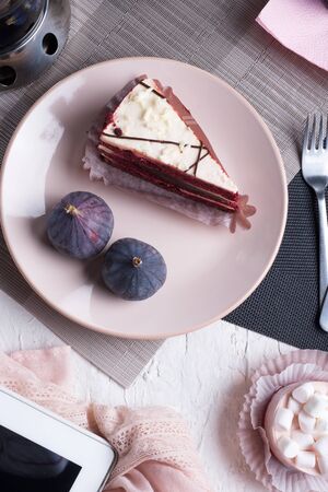 life style set at meeting in cafe.Thai blue, Butterfly pea tea served with fresh figs and panna cotta cake and fruit piece of cake on serving napkins. flat layの写真素材