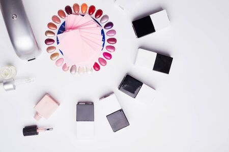set for manicure with gell polish  bottles, LED lamp and accessoires on white background. flat layの写真素材