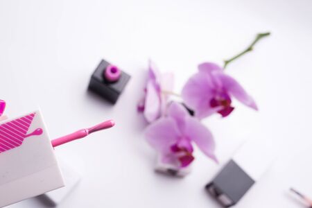 applicator of gel polish with pink polish around blur  background. selective focus. close up.の写真素材