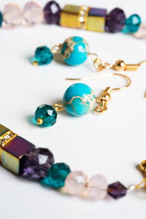 gold jewerly braslete with semiprecious and cristal at white backgroundの写真素材