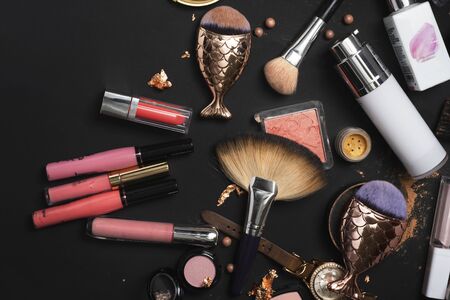 Set of luxury cosmetics with makeup brushes on black backgroundの写真素材