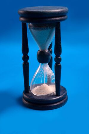 blue hourglass over bluebackground. close upの写真素材